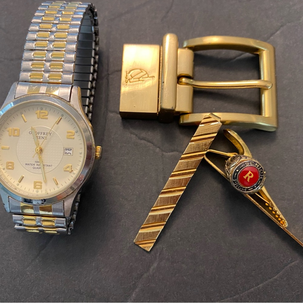 Mixed Men and Woman jewelry. Watch, necklaces, charms, tie pins, belt buckle.